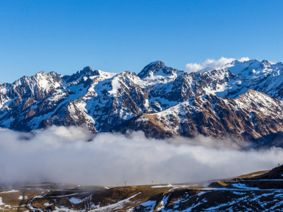 Snow and mountain peaks in the french Pyrenees near the Luchon Superbagnères Ski Resort in the Arrondissement of Saint-Gaudens, Occitania, Haute-Garonne, France. The Luchonnais Mountains aerial view.